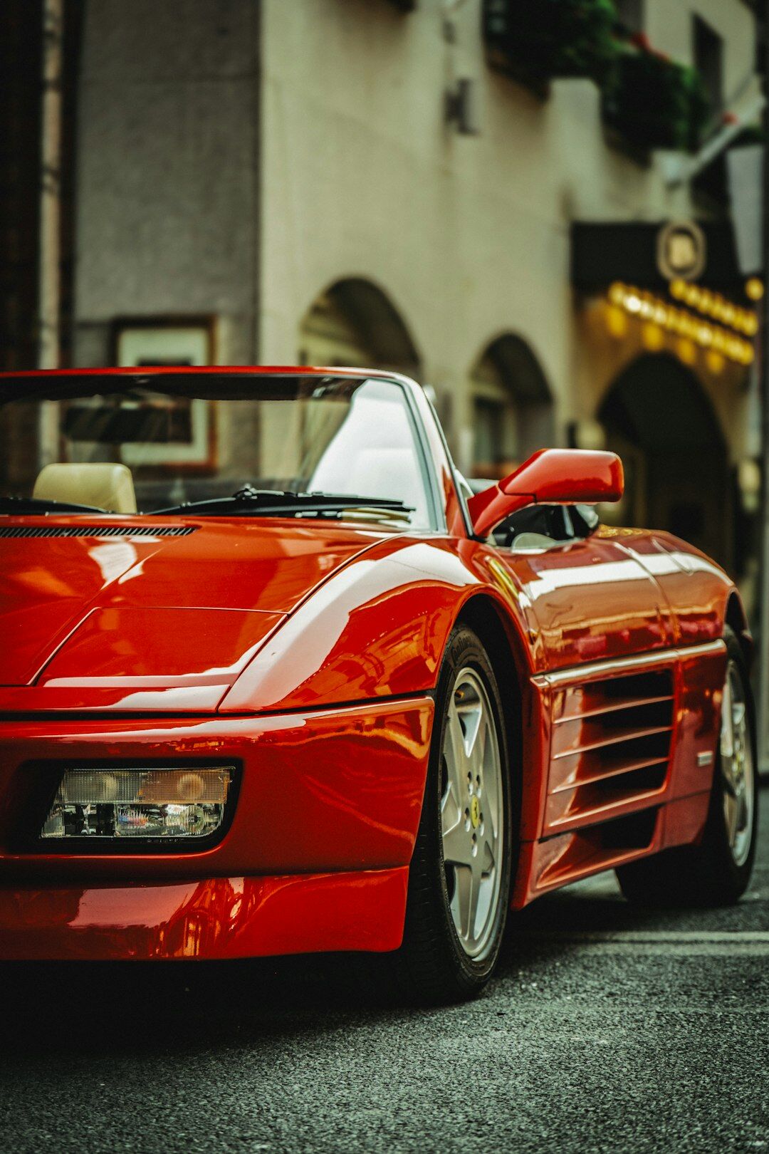 Vintage Ferrari parked on a historic cobblestone street in Montevideo at dusk