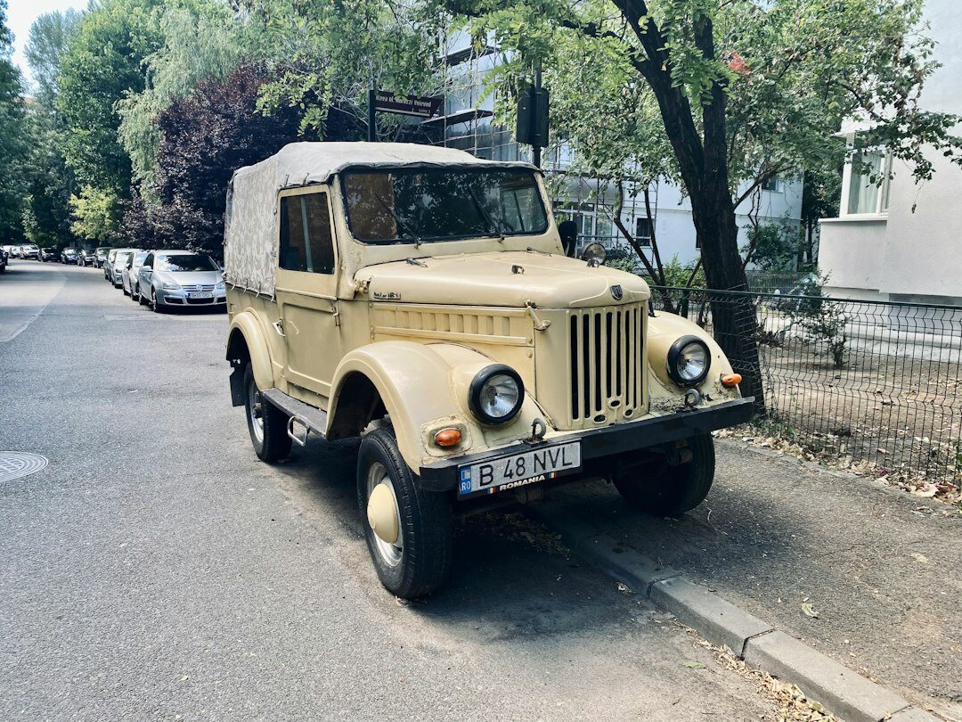 Portrait of an elegant Uruguayan car collector standing beside a vintage automobile