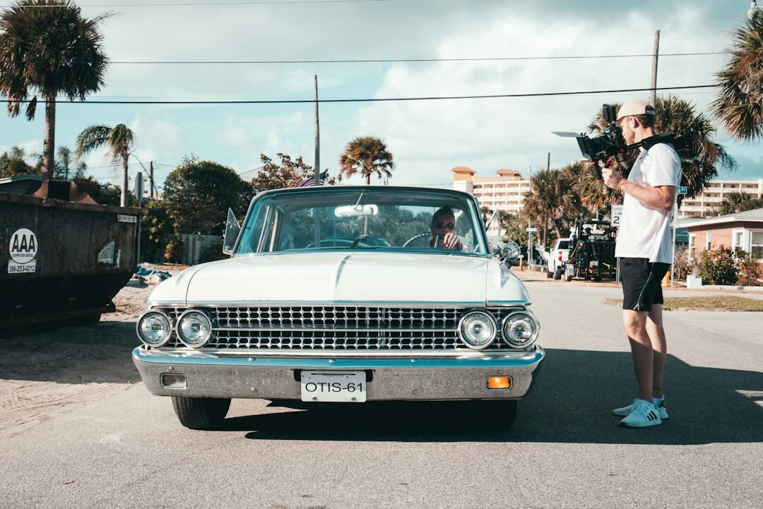 Photographer capturing a vintage automobile for an editorial feature