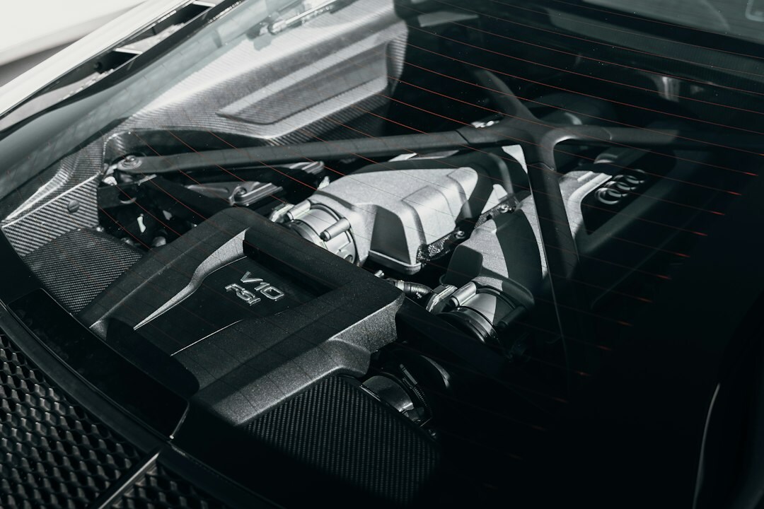 Close up detail of a W16 hypercar engine bay with exposed carbon fiber