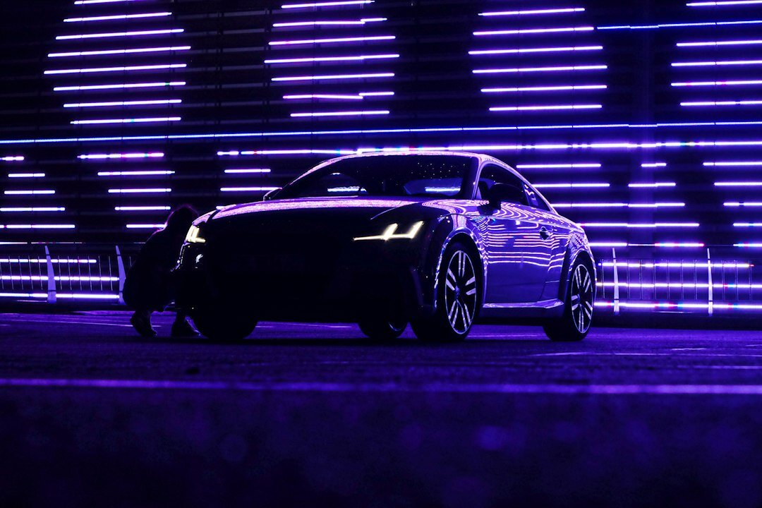 Electric performance hypercar with illuminated LED details parked at night in Montevideo