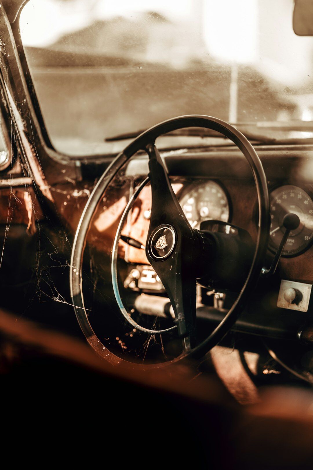 Detailed interior shot of a vintage automobile dashboard and leather seats