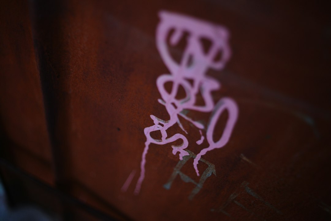 Close up of a dust covered vintage automobile badge inside a forgotten garage