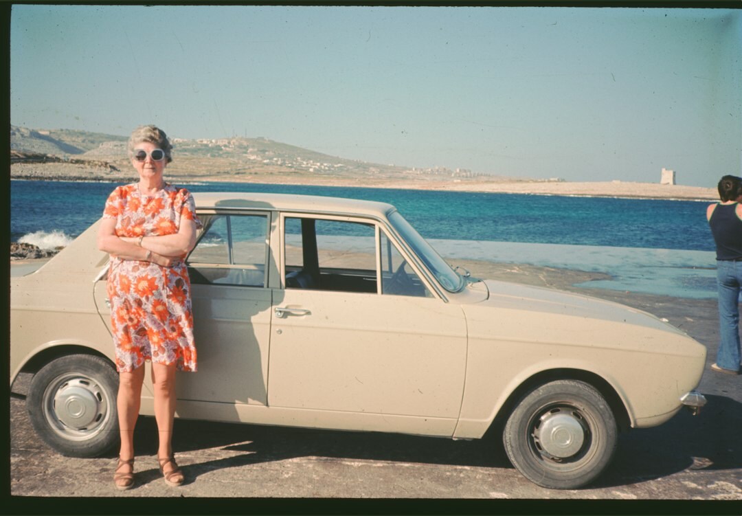 1960s European classic sports car with round headlights on a coastal Uruguayan road