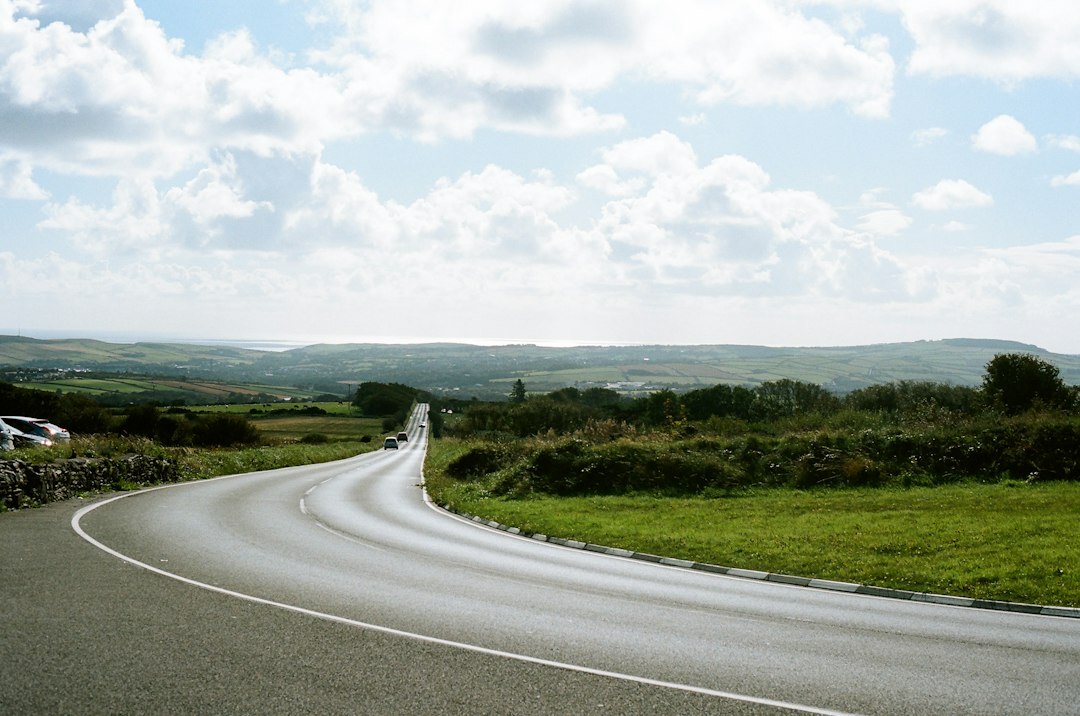 Convoy of classic automobiles driving along a rural Uruguayan highway